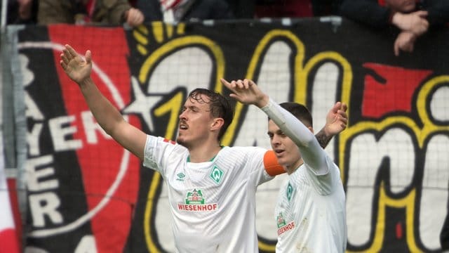 Die Bremer Torschützen Milot Rashica (r) und Max Kruse feiern den Auswärtssieg.