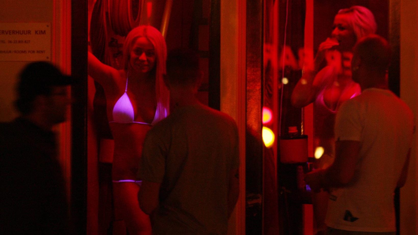 Tourists looks for girls at Red Light District in Amsterdam Netherlands Tourists looks for girls at Red Light District in Amsterdam Netherlands