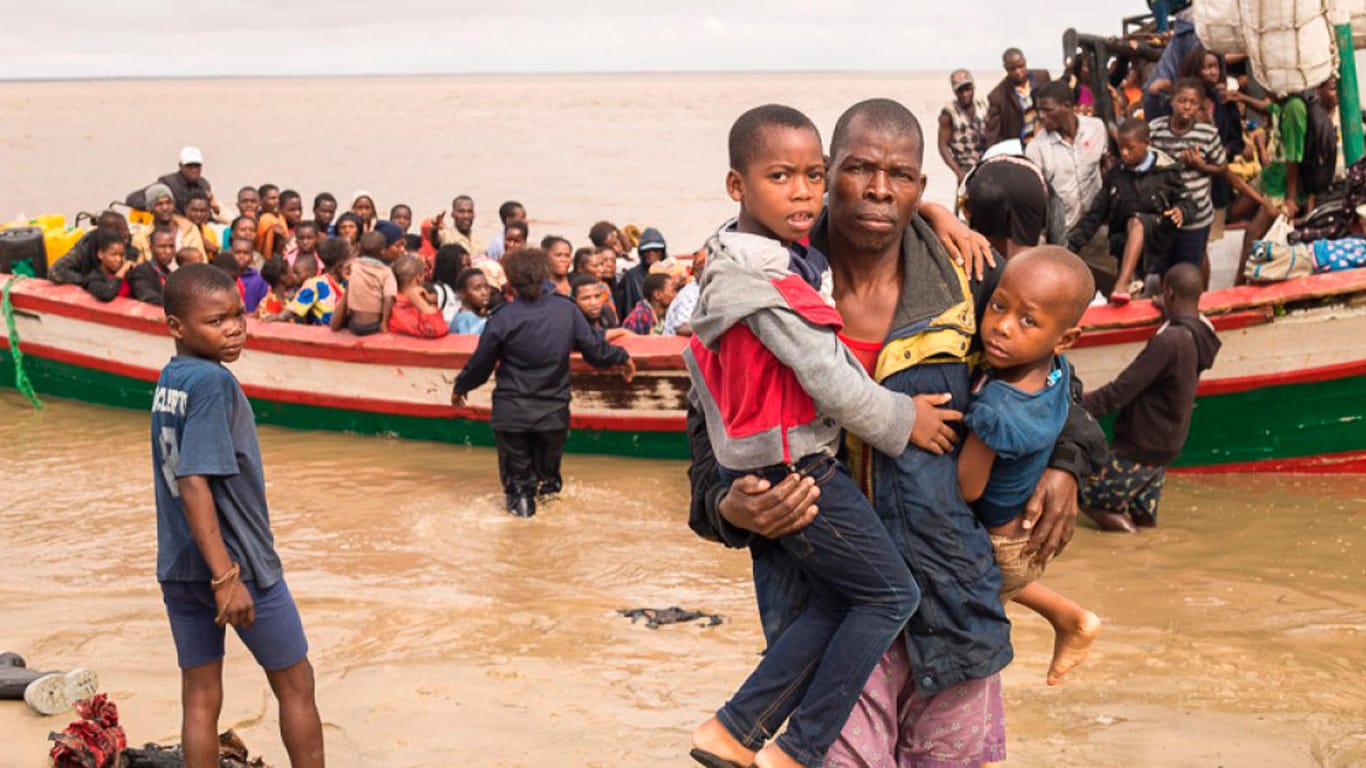 Überlebende des Zyklons in Mosambik: Ein Boot mit Menschen legt am Meeresufer an.