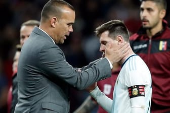 Venezuelas Trainer Rafael Dudamel (l) tröstet Lionel Messi nach der Niederlage der Argentinier.