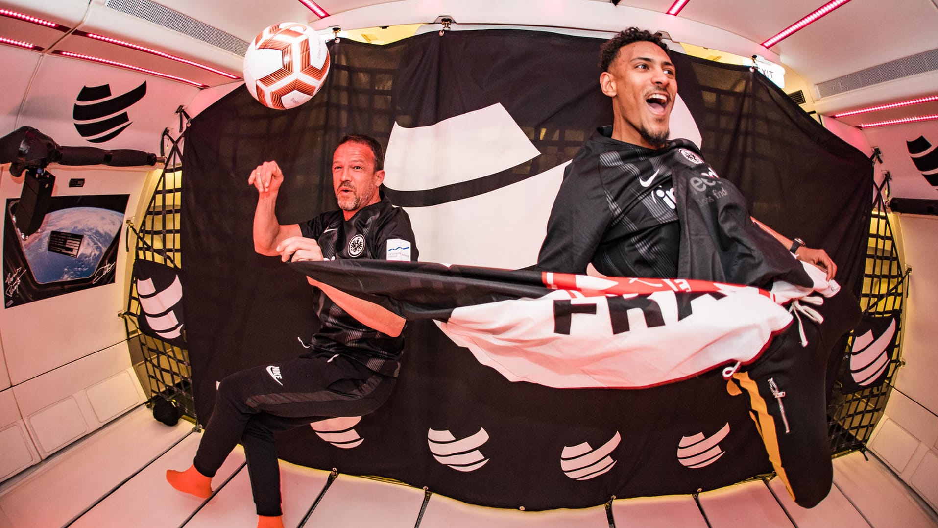 Fredi Bobic und Eintracht-Stürmer Sébastien Haller schweben durch einen speziell ausgebauten Airbus.