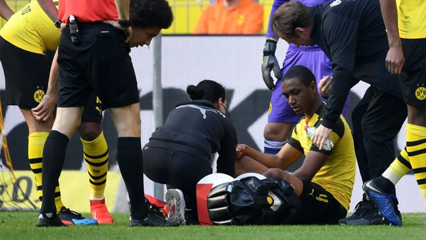 Dortmunds Abdou Diallo sitzt nach einer Verletzung auf dem Platz.