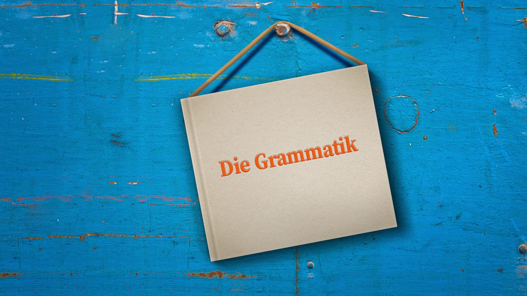 Ein Grammatikbuch hängt am Nagel: Vielen ist die Bedeutung des transitiven Verbs hängen – hängte – gehängt im Gegensatz zum intransitiven hängen – hing – gehangen nicht bekannt oder geläufig.