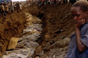 Ein Flüchtlingsjunge in Ruanda blickt auf ein Massengrab: Der damalige Bundeskanzler Helmut Kohl beließ es bei einem Statement zu Völkermord in Ruanda: Er dankte sich bei seinem belgischen Kollegen für die Hilfe Belgiens bei der Evakuierung deutscher Staatsbürger.