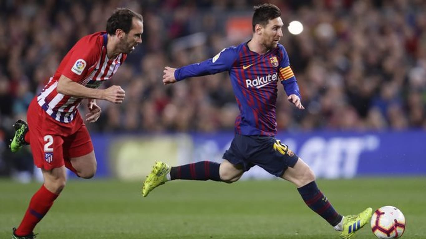 Barcelonas Lionel Messi (r) und Atleticos Diego Godin liefern sich ein hitziges Duell.
