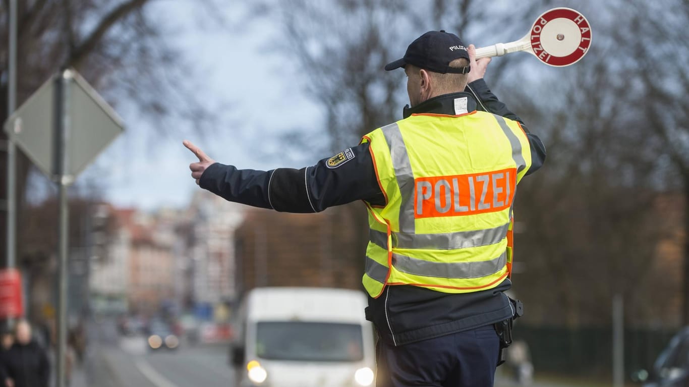 Ein Polizist winkt an der deutsch-polnischen Grenze in Görlitz einen Transporter zu einer Kontrolle heraus. (Archivbild)