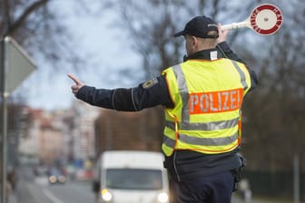 Ein Polizist winkt an der deutsch-polnischen Grenze in Görlitz einen Transporter zu einer Kontrolle heraus. (Archivbild)