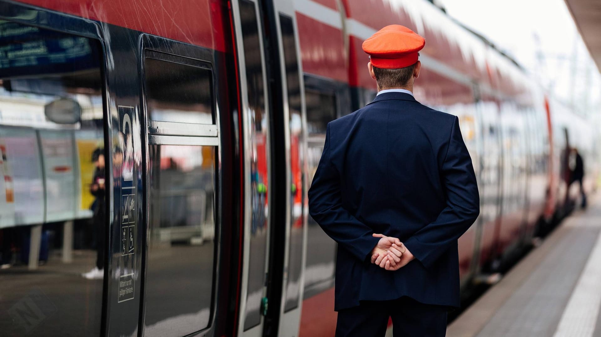 Ein Schaffner beobachtet die Abfahrt einer Regionalbahn: Wer in den Zug steigt, braucht ein gültiges Ticket.