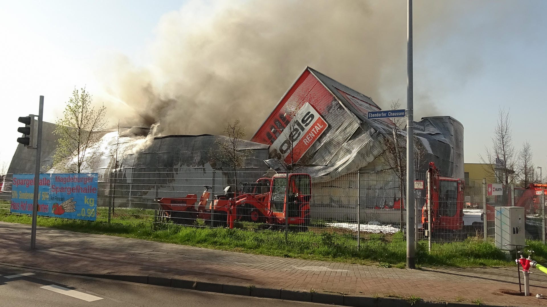 Rauch steigt aus einer eingestürzten Lagerhalle auf: Die Polizei schätzt den Schaden auf eine sechsstellige Summe.