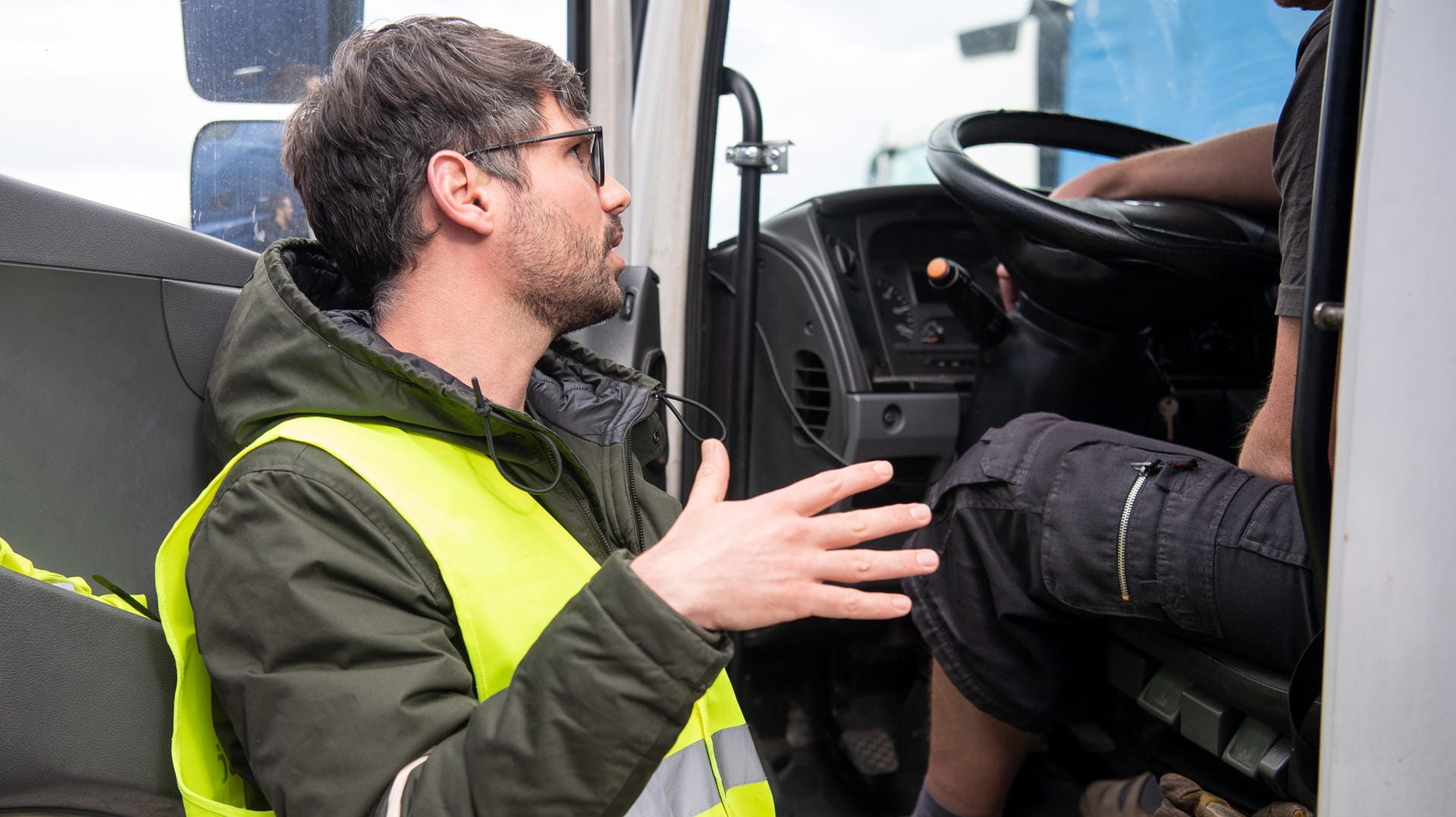 Aufklärungsarbeit des DGB: Michael Wahl, Koordinator "Informationsprojekt für Lkw-Fahrer aus Mittel- und Osteuropa" beim DGB, spricht während einer Aktion auf der Autobahnraststätte Hohenlohe Süd an der A6, bei der Mitarbeiter des Deutschen Gewerkschaftsbundes vorwiegend osteuropäische Lastwagenfahrer beraten, mit einem Lastwagenfahrer.