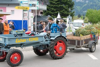 Ein Traktor auf dem Weg zum traditionellen Maibaumaufstellen (Symbolfoto): Ein Fahrzeug mit mehreren Mitfahrern ist in Oberbayern umgekippt – 21 Menschen wurden zum Teil schwer verletzt.
