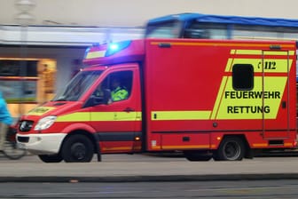 Feuerwehr-Rettungswagen mit Blaulicht (Symbolbild): Ein Baukran ist in Schleswig-Holstein auf ein Gebäude gestürzt und hat großen Schaden verursacht.