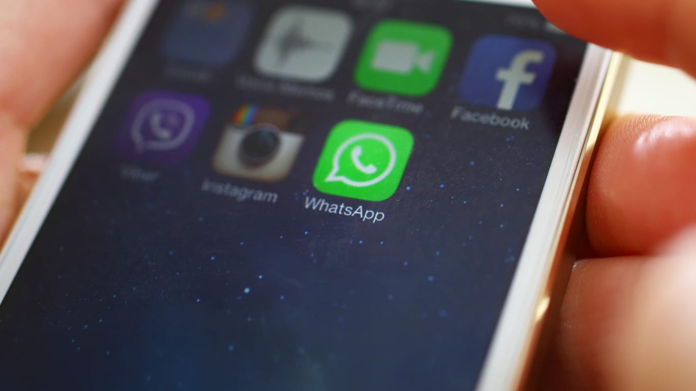 Eine Nutzerin hält ein Smartphone, auf dem WhatsApp installiert ist: Der Messenger will offenbar jedem Nutzer einen QR-Code zuordnen.
