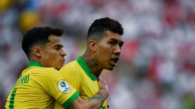 Roberto Firmino (r) lässt sich nach seinem Treffer feiern.