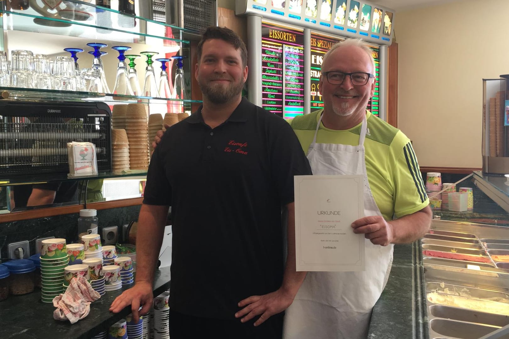 Jerome Kuhn und Claus-Jürgen Kuhn (rechts) freuen sich über die Urkunde für die beste Eisdiele in Karlsruhe.