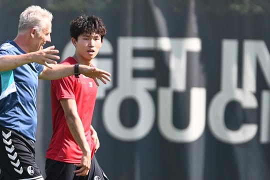 Freiburg-Coach Christian Streich (l) mit Neuzugang Wooyeong Jeong.