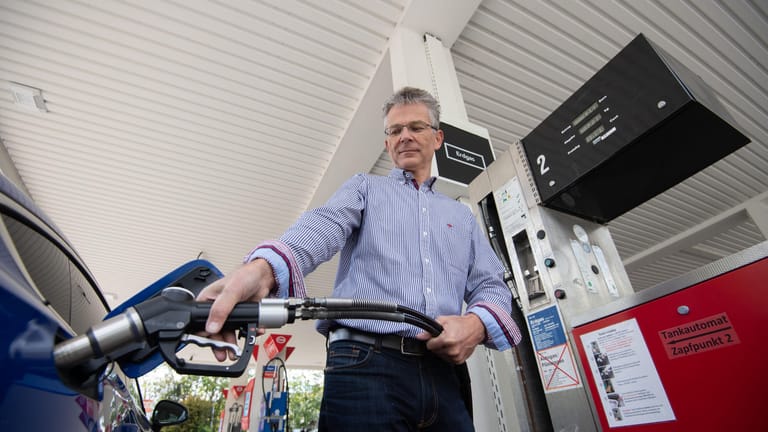 Ulrich Müller hält den Zapfhahn einer Erdgas-Tanksäule an sein Erdgasauto: Der Autobesitzer räumt ein, dass der alternative Kraftstoff nicht zu viel hätte kosten dürfen.