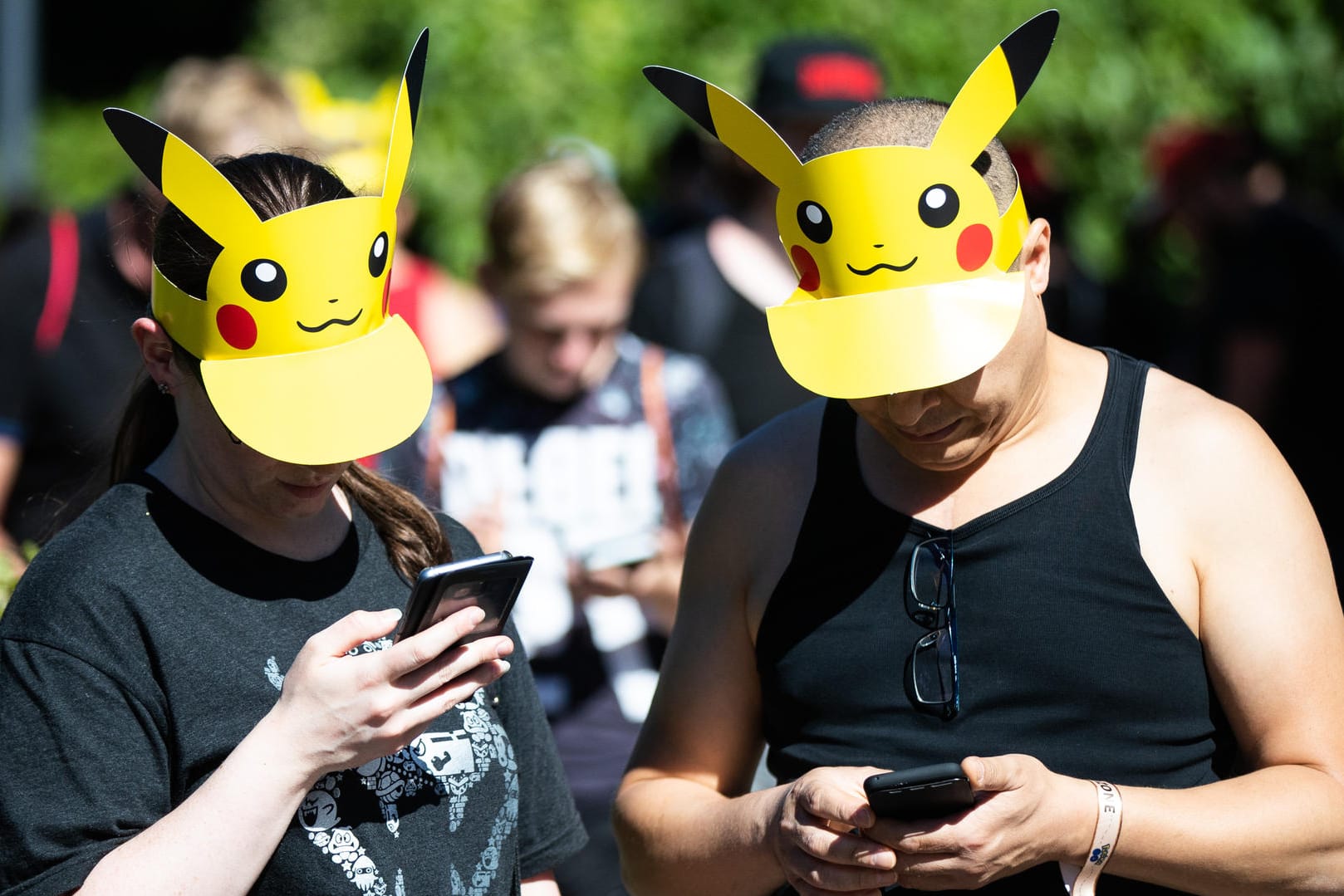 Teilnehmer mit Pokemon-Sonnenschutz spielen im Westfalenpark: Zu einem "Pokémon Go"-Fest in Dortmund werden ab Donnerstag Zehntausende Fans aus ganz Deutschland und Europa erwartet.