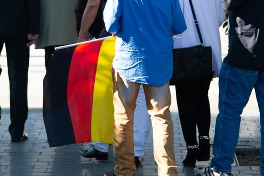 Ein Teilnehmer des "Flügel"-Treffens mit einer Deutschland-Flagge.