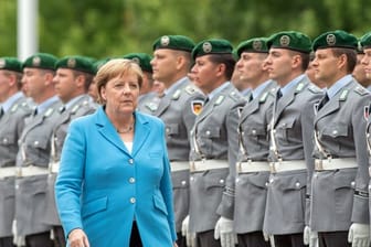 Kanzlerin Merkel vor Soldaten des Wachbataillons im Ehrenhof des Bundeskanzleramts.
