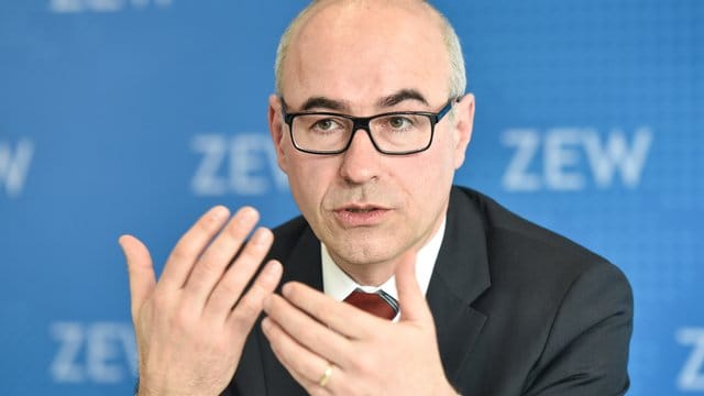 Achim Wambach gestikuliert bei Pressekonferenz