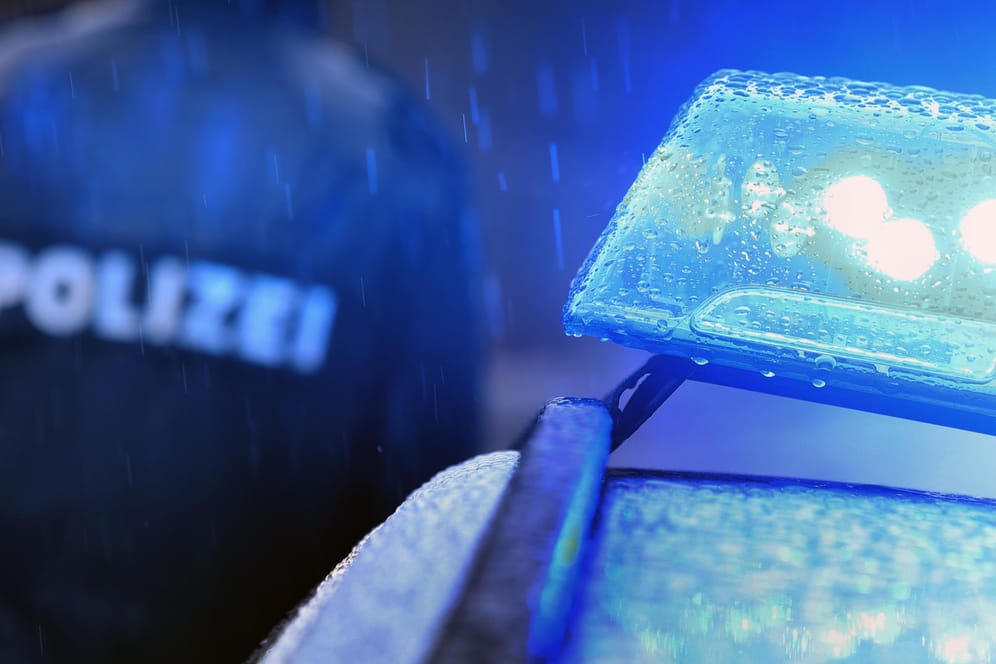 Ein Polizist vor einem Streifenwagen (Symbolbild): Nach dem Missbrauch einer 15-Jährigen in Bergkamen ist ein Verdächtiger festgenommen worden.