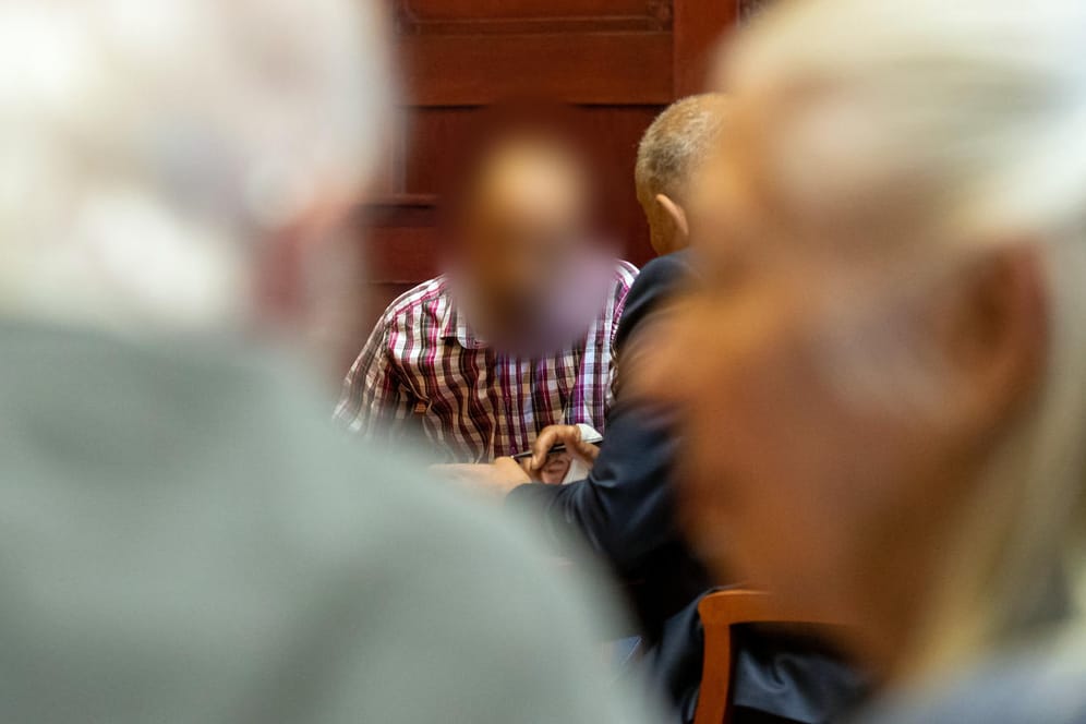 Ein wegen Mordes angeklagter Marokkaner (M.) sitzt vor Prozessbeginn im Sitzungssaal im Landgericht Bayreuth. Im Vordergrund sitzen die Eltern des Opfers.