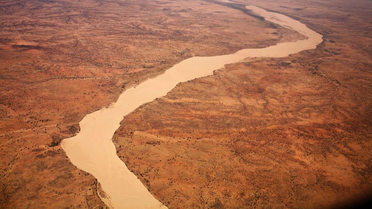 A dried up river filled with sand winds its way across the desert near Gos Beida in eastern Chad