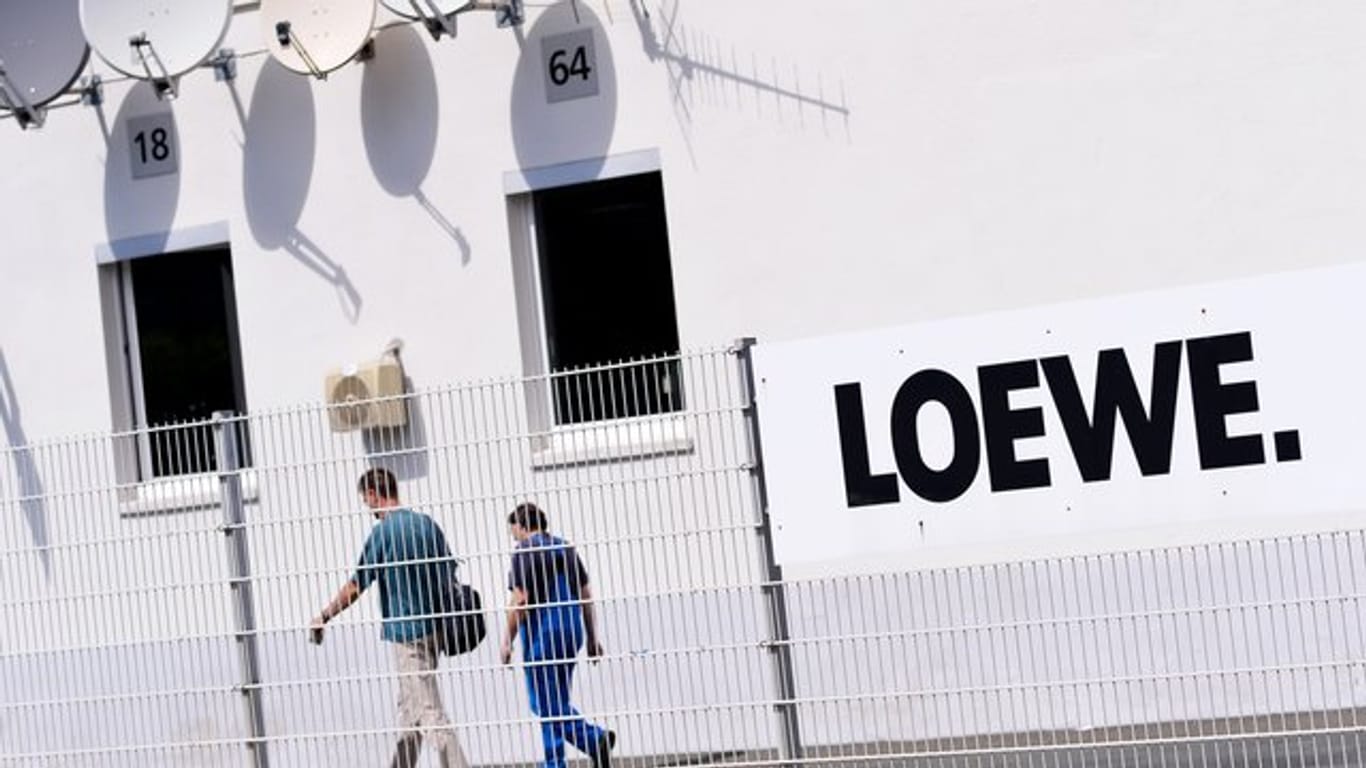 Zwei Mitarbeiter gehen über das Gelände des Elektronikherstellers Loewe AG: Für ein Großteil der Belegschaft ist heute der letzte Arbeitstag bei dem Traditionsunternehmen.