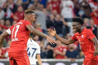 Torschütze Alphonso Davies (r) und Jerome Boateng vom FC Bayern München jubeln über den Treffer zum 2:2.