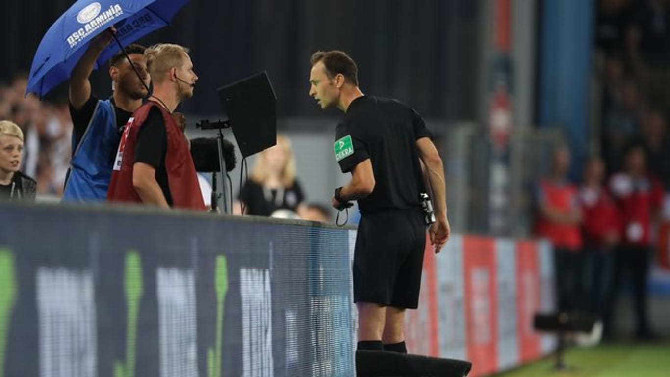 Schiedsrichter Bastian Dankert bedient sich des Videobeweises beim Spiel Bielefeld gegen St.