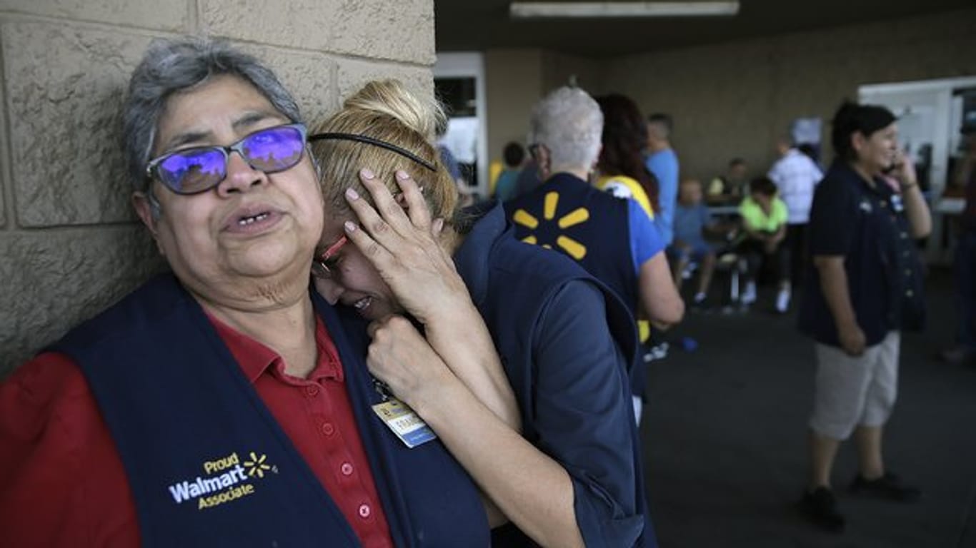 Fassungslos stehen Mitarbeiter von Walmart vor der Tür des Ladenkomplexes in El Paso.