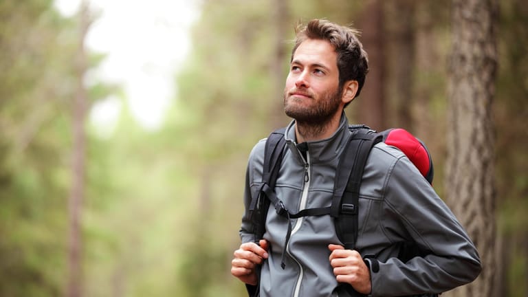 Outdoorjacke für Herren kaufen: Mit einer Funktionsjacke sind Sie beim Wandern im Wald vor allen Wetterumschwüngen sicher.