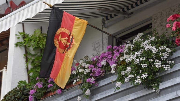 Kurz vor der Wahl in Brandenburg weht eine DDR-Flagge vom Balkon eines Plattenbaus in Frankfurt (Oder).