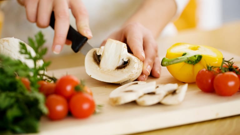 Pilze und Gemüse zubereiten: Die Ernährung spielt eine wichtige Rolle bei der Entstehung von Krankheiten.