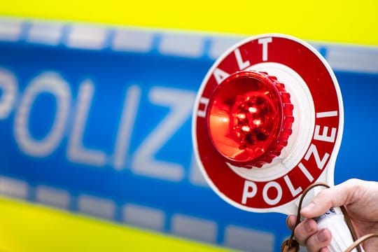 Ein Polizist bittet um Anhalten: In Köln wurden zwei Autofahrer gestoppt, die sich ein illegales Autorennen geliefert haben.