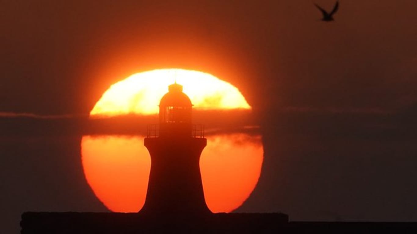 Sonnenaufgang im August hinter dem South Shields Leuchtturm an der Mündung des Tyne in Großbritannien.