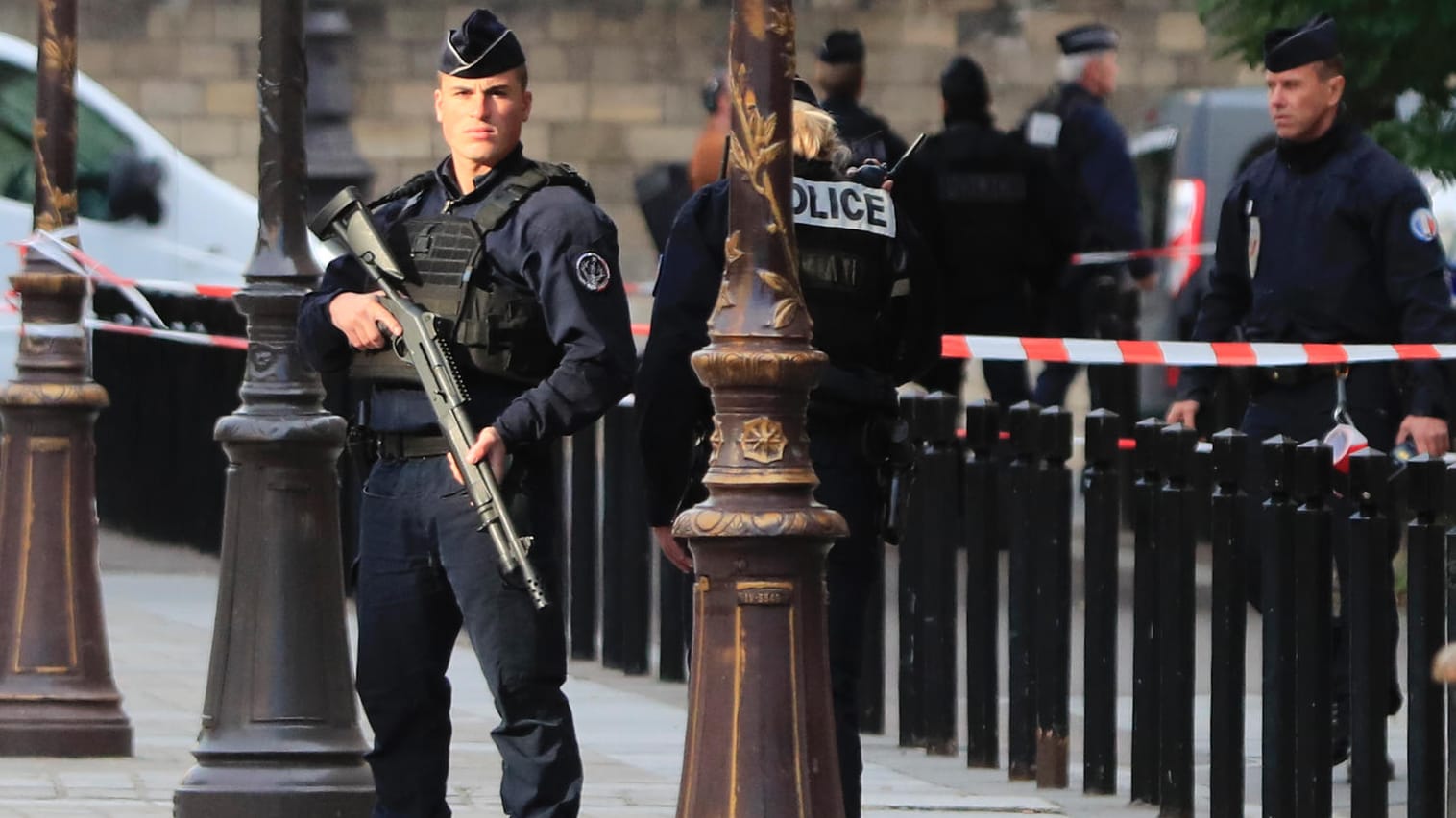 Polizisten stehen nach der Messerattacke Wache: Es werden neue Details über den mutmaßlichen Täter bekannt.