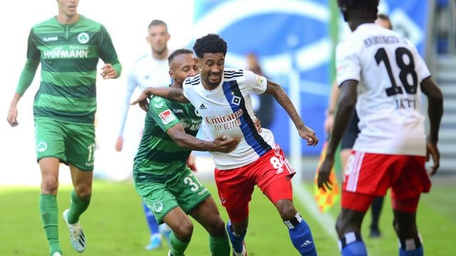 Fürths Julian Green (M,l-r) und HSV-Spieler Jeremy Dudziak kämpfen um den Ball.