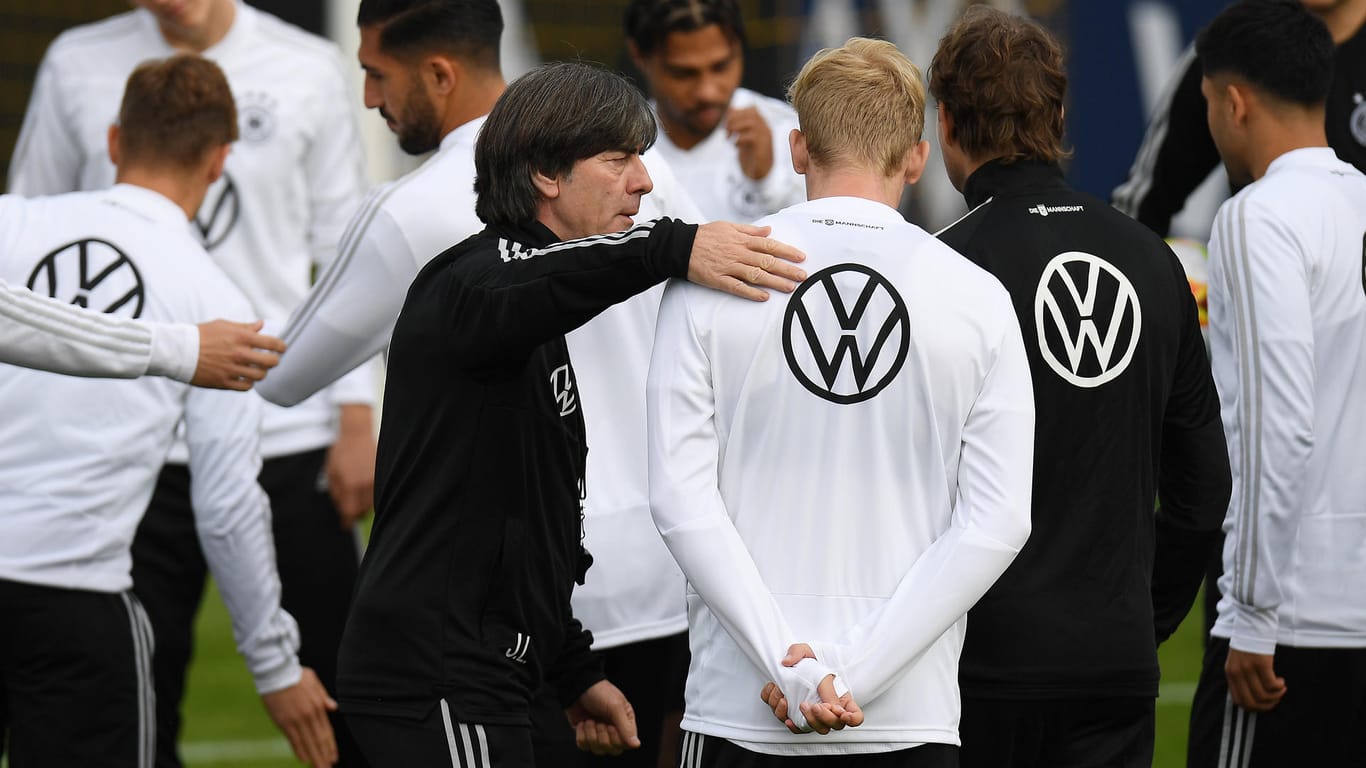 Bundestrainer Joachim Löw klopft Julian Brandt auf die Schulter: Der BVB-Profi könnte eine Chance in der Startelf bekommen.