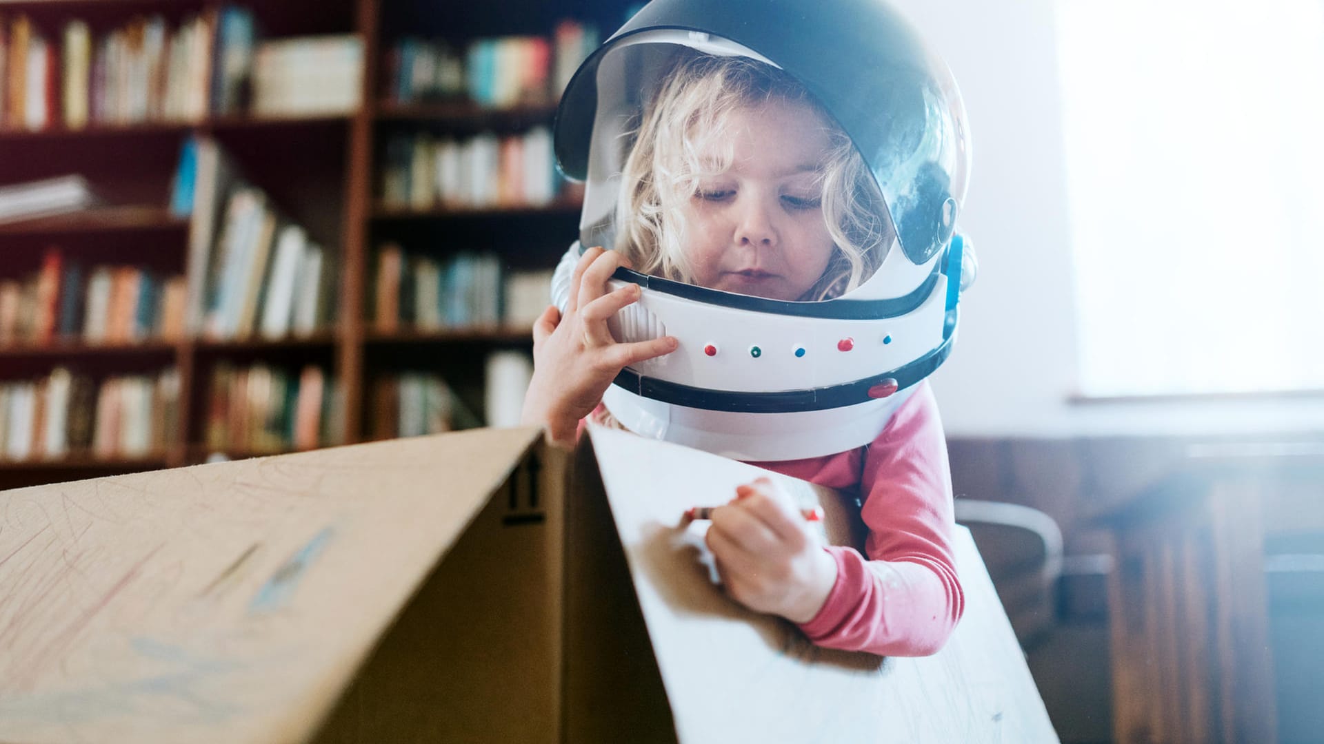 Children Imagine Space Adventure in Cardboard Box