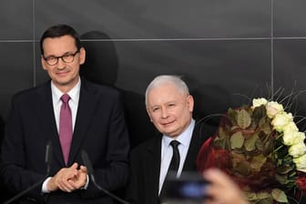 Polens Regierungschef Mateusz Morawiecki (l) und Jaroslaw Kaczynski (r), Vorsitzender der PiS-Partei, am Wahlabend in Warschau.