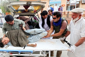 Männer tragen einen Verletzten in ein Krankenhaus: Bei einem Anschlag in einer Moschee sind mindestens 60 Menschen gestorben.