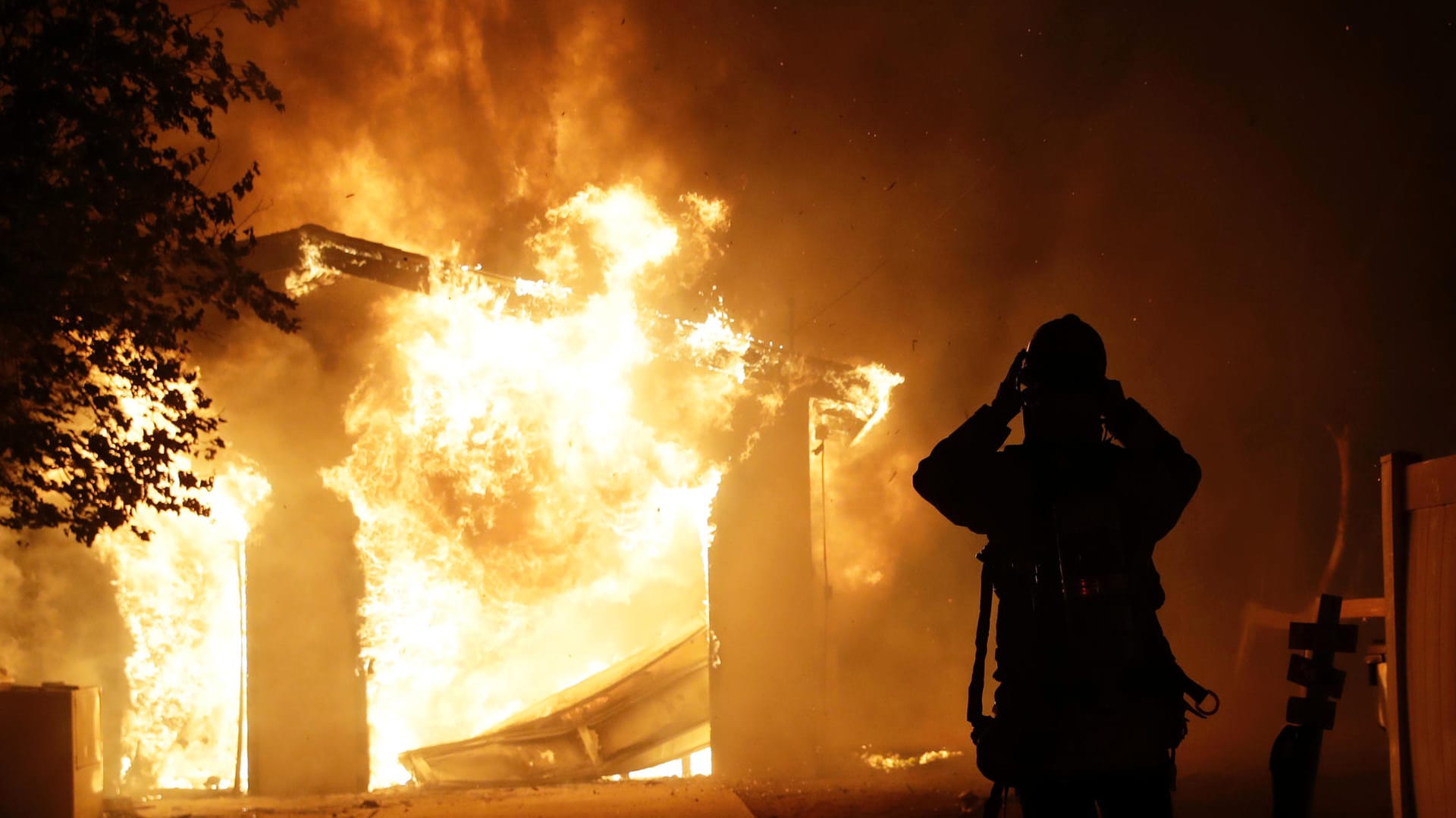 Ein Feuerwehrmann vor einem brennenden Haus in Santa Clarita: Ein schnell um sich greifender Waldbrand tobt in Kalifornien.