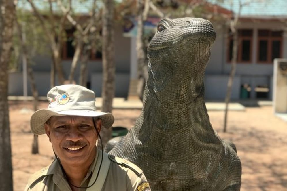 Chef-Ranger Johanes Rawineben neben einem Drachen-Denkmal im Nationalpark von Komodo: Die Insel ist zurzeit ein echter Touristenmagnet.