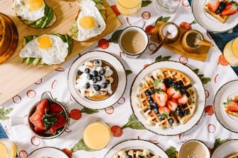 Ein gut gedeckter Frühstückstisch mit Waffeln und Co.: Wir stellen Ihnen die besten Restaurants und Food-Spots vor.