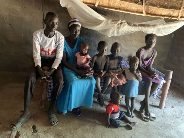 Nyamon Piok mit ihren Kindern in ihrer Hütte.