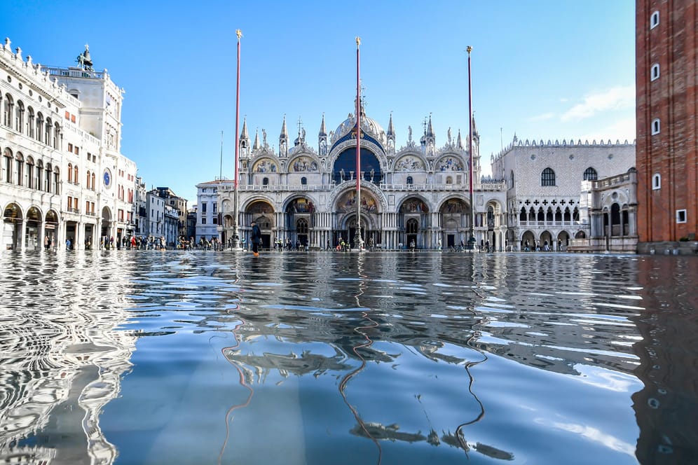 Der Dogenpalast spiegelt sich im Hochwasser auf dem Markusplatz: Nicht nur Venedig leidet in diesen Tagen unter Extremwetter.