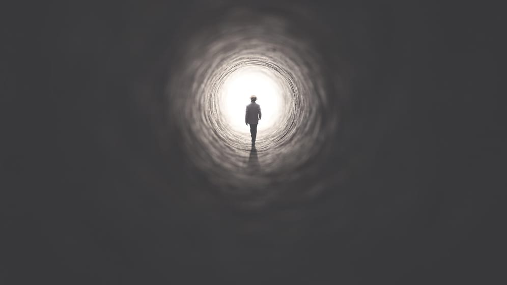 Ein Mann geht ins Licht: Es gibt ganz unterschiedliche Vorstellungen darüber, was nach dem Tod mit uns Menschen passiert.