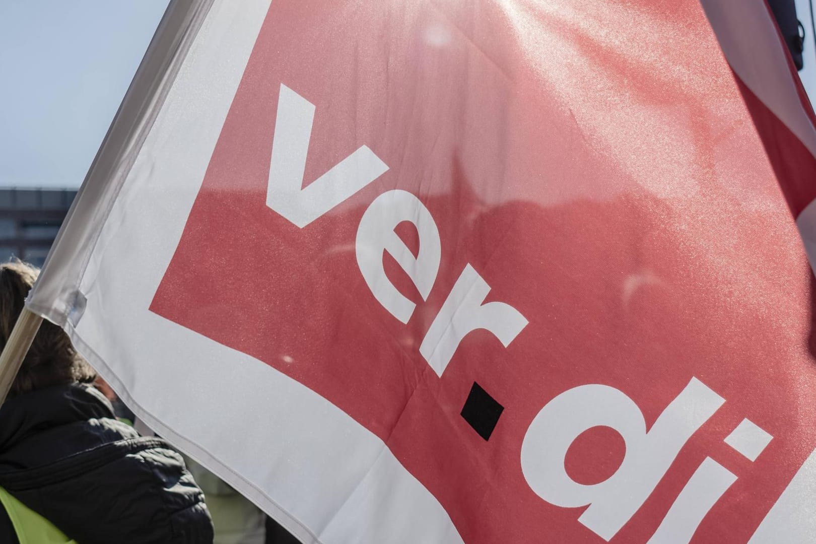 Ein Demonstrant hält eine Verdi-Fahne: In Karlsruhe werden Hunderte Versicherer bei einer Kundgebung erwartet.